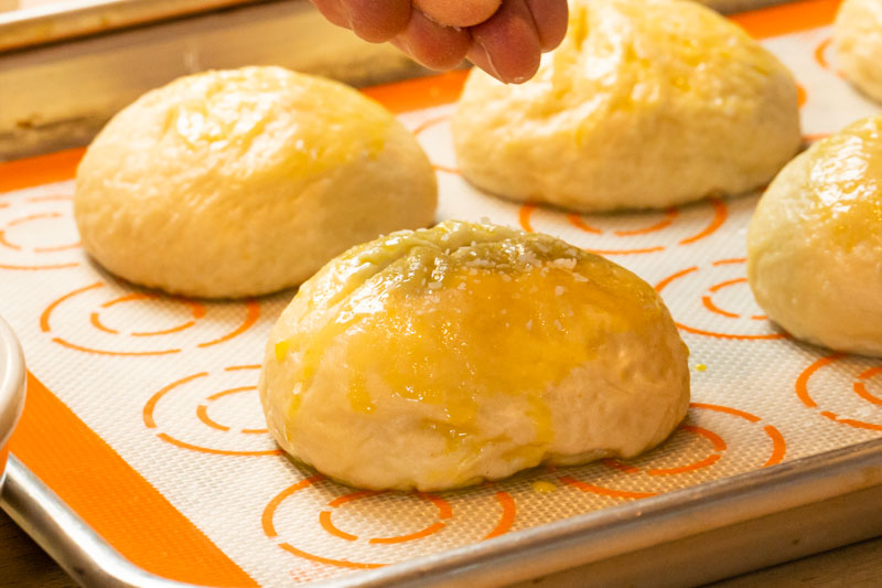 Adding salt to pretzel buns