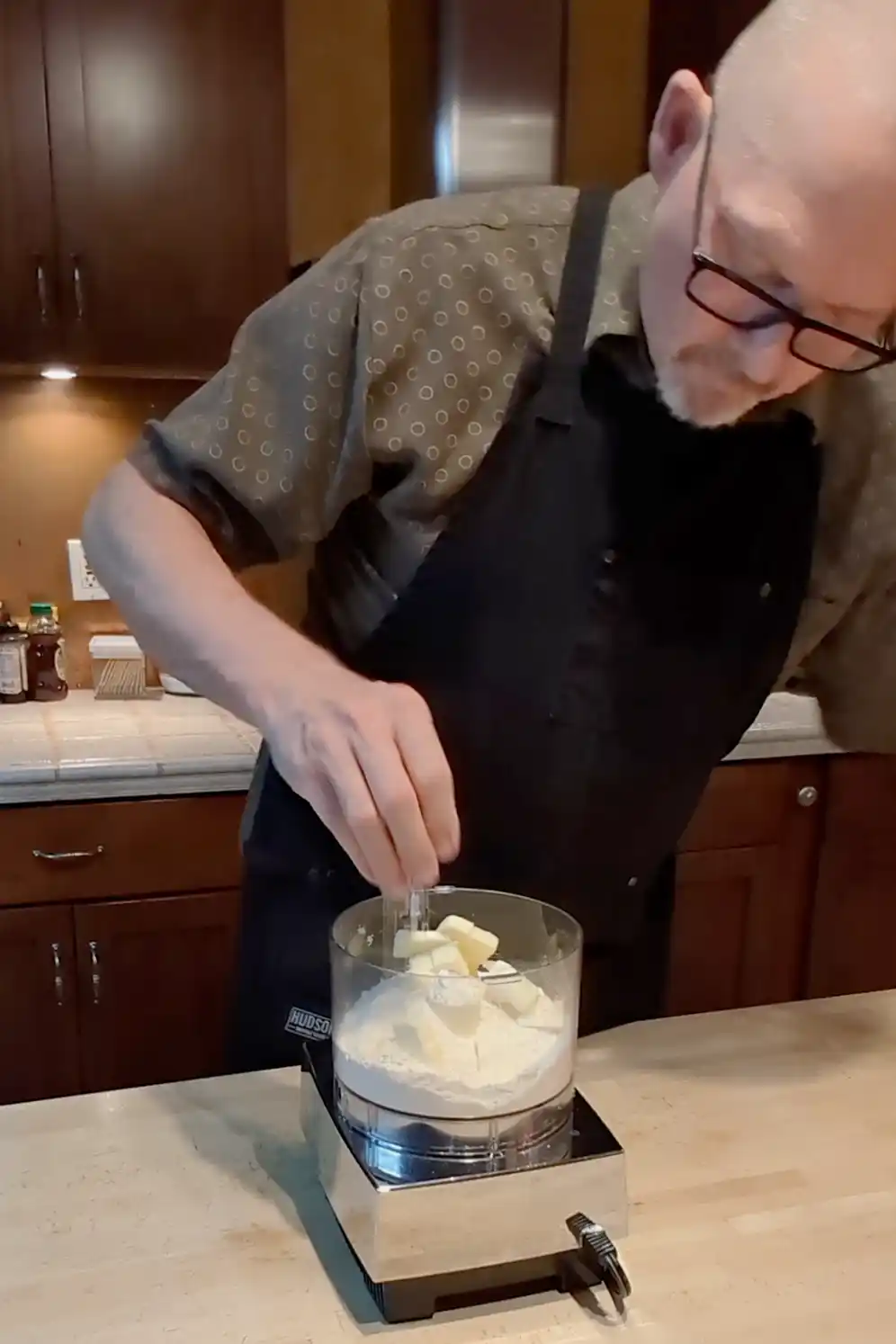Cheeseburger Guru adding flour, salt, and butter to a food processor