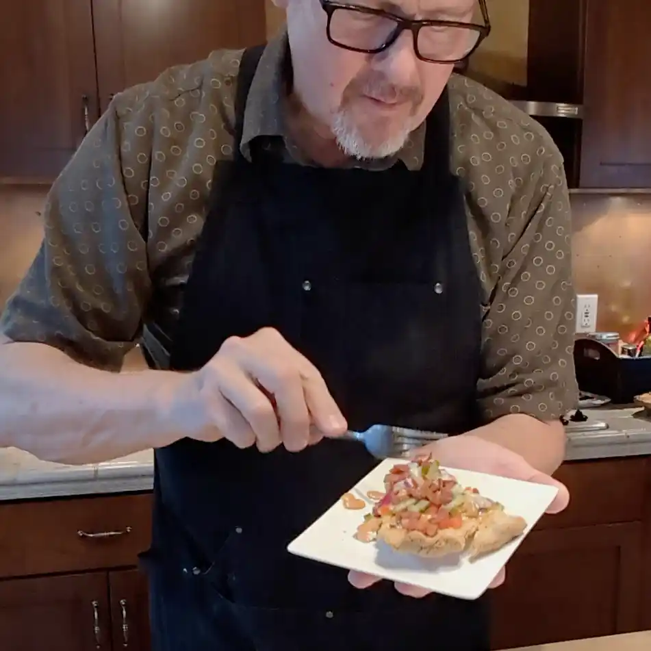 Cheeseburger Guru tasting a slice of bacon cheeseburger quiche.